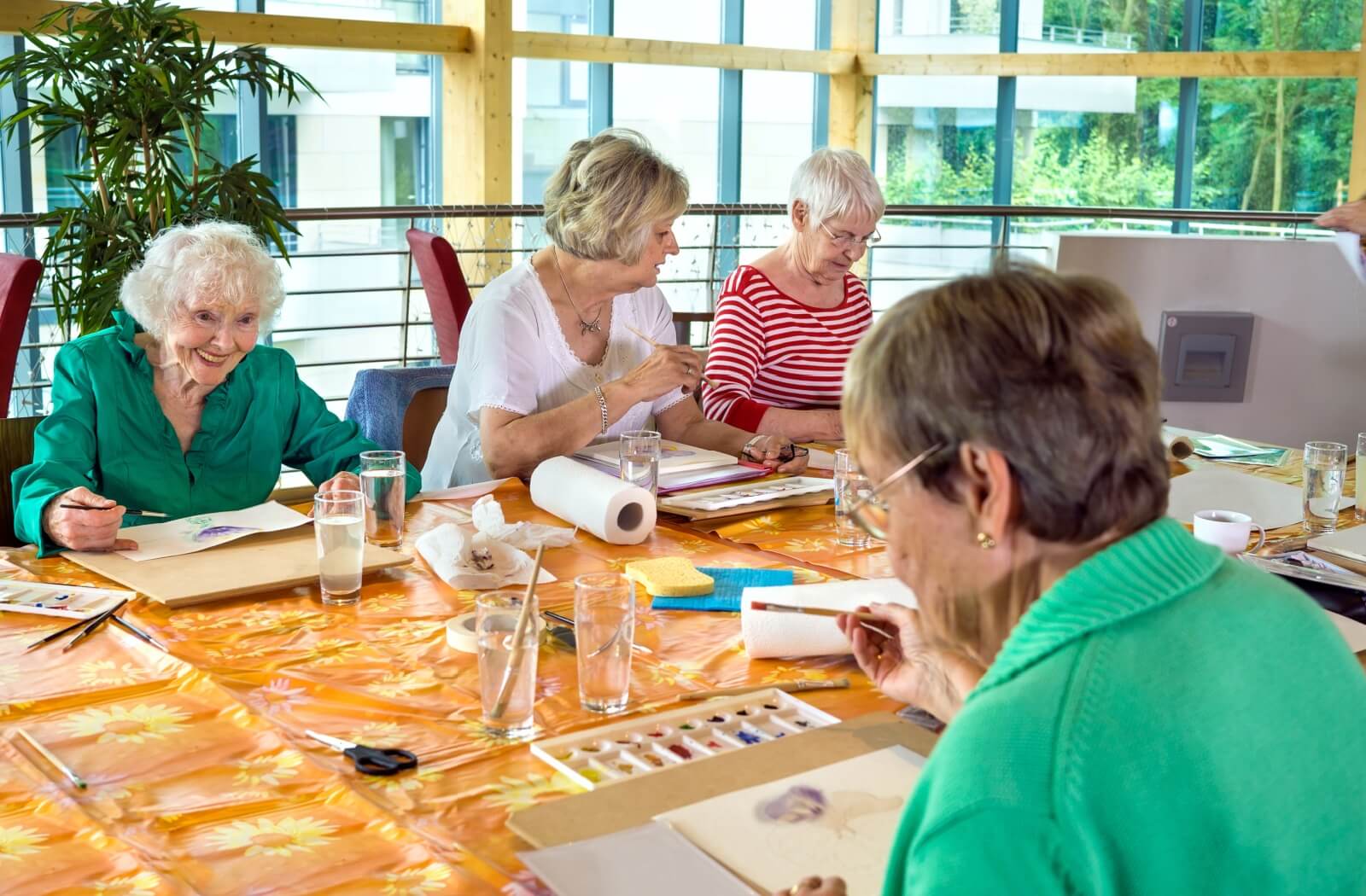 seniors enjoying a painting activity in memory care